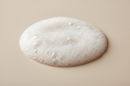 very light foam that is not as fluffly and more liquid foam cleanser, light beige background 